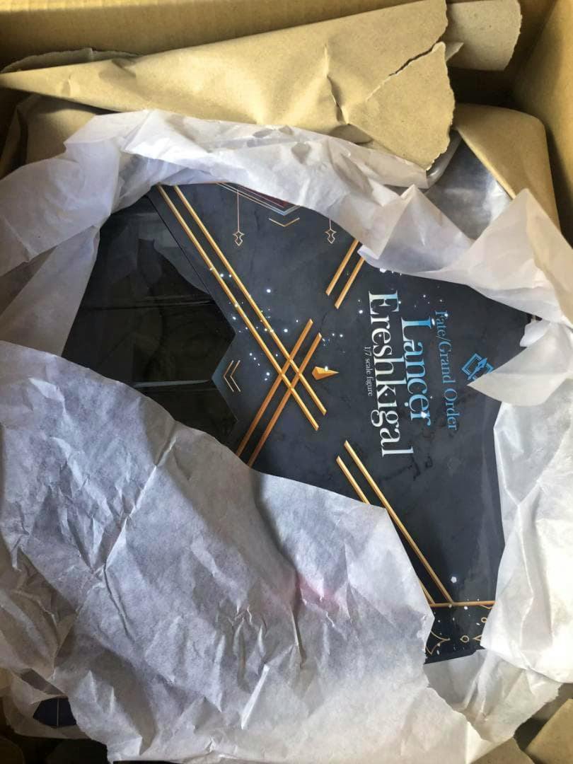 Photo of the Lancer / Ereshkigal 1/7 scale figure retail box partially wrapped in packing tissue inside a shipping box.