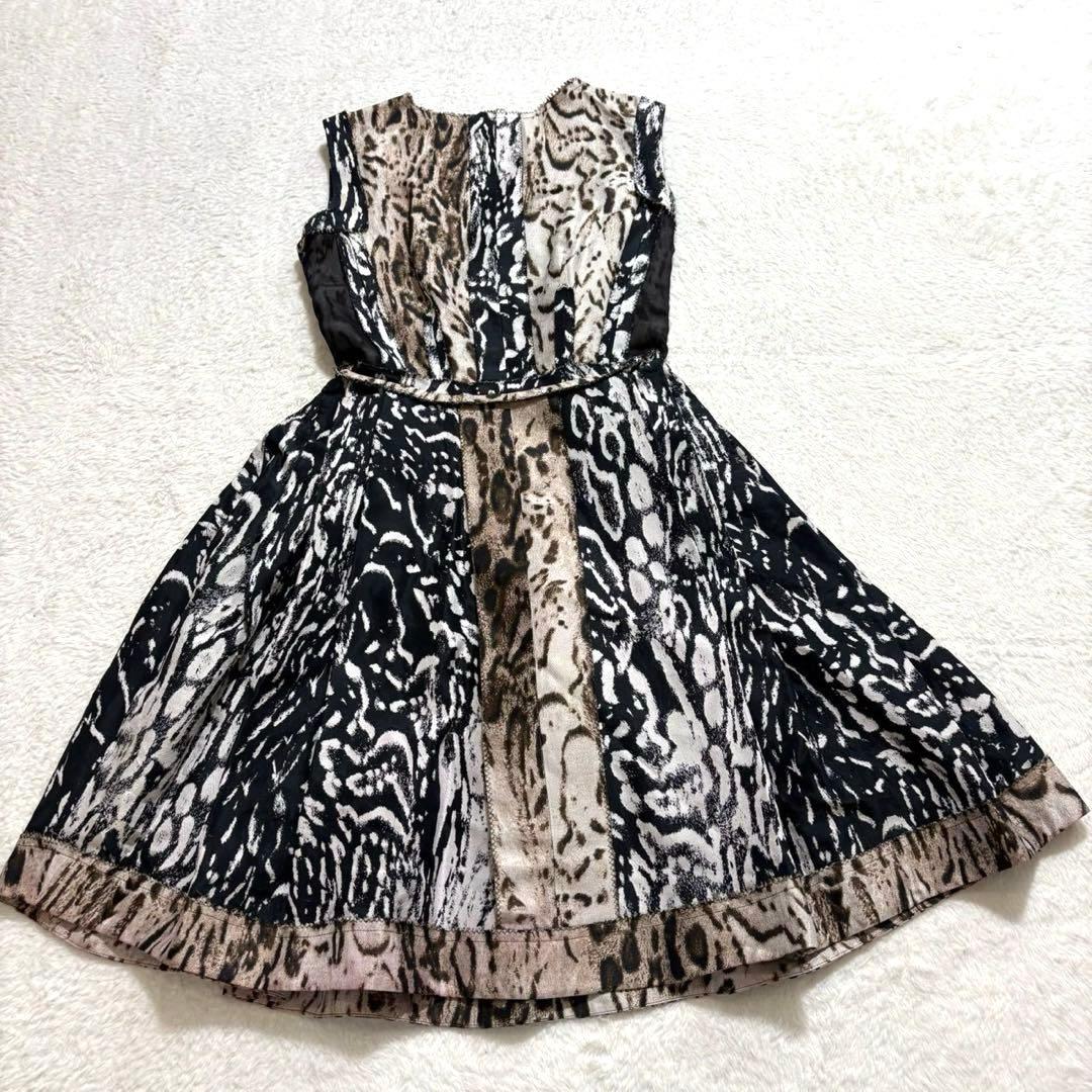 Silk sleeveless leopard-print dress laid flat showing the full front and skirt.