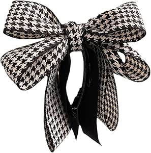 Black-and-white houndstooth patterned ribbon bow attached to a large banana hair clip.