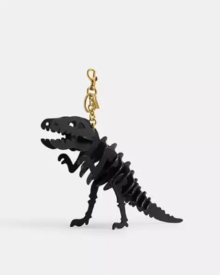 Front-facing black dinosaur skeleton bag charm keychain with a gold lobster clasp against a white background.