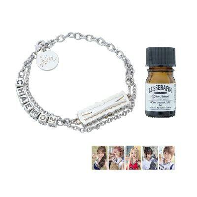 Silver-tone chain aroma bracelet with charms shown beside a small amber aroma oil bottle.