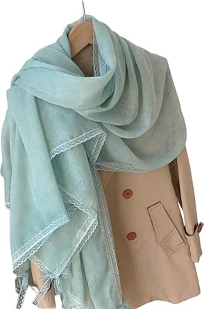A light green, thin rectangular polyester scarf with lace trim draped over a beige coat on a hanger.