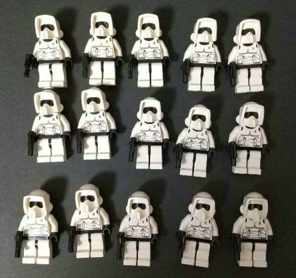 Fifteen white LEGO Star Wars-style minifigures lined in rows on a dark background, wearing helmets and holding black blasters.