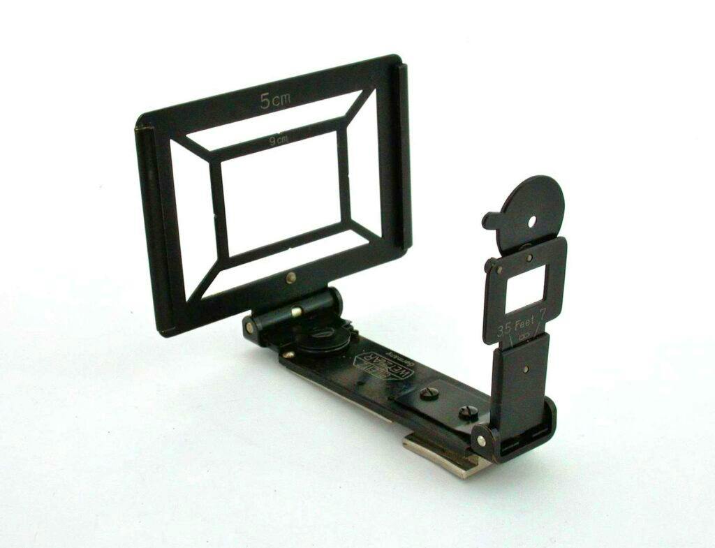 An unfolded metal camera viewfinder showing rectangular framing masks and a hinged mounting base.
