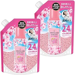 Two pink Lenor Aroma Jewel Sakura laundry scent booster refill pouches with cherry blossom graphics.