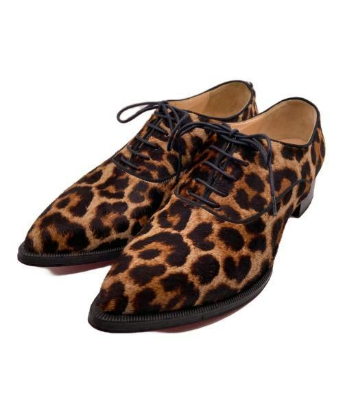 Pair of leopard-pattern lace-up shoes on a white background.