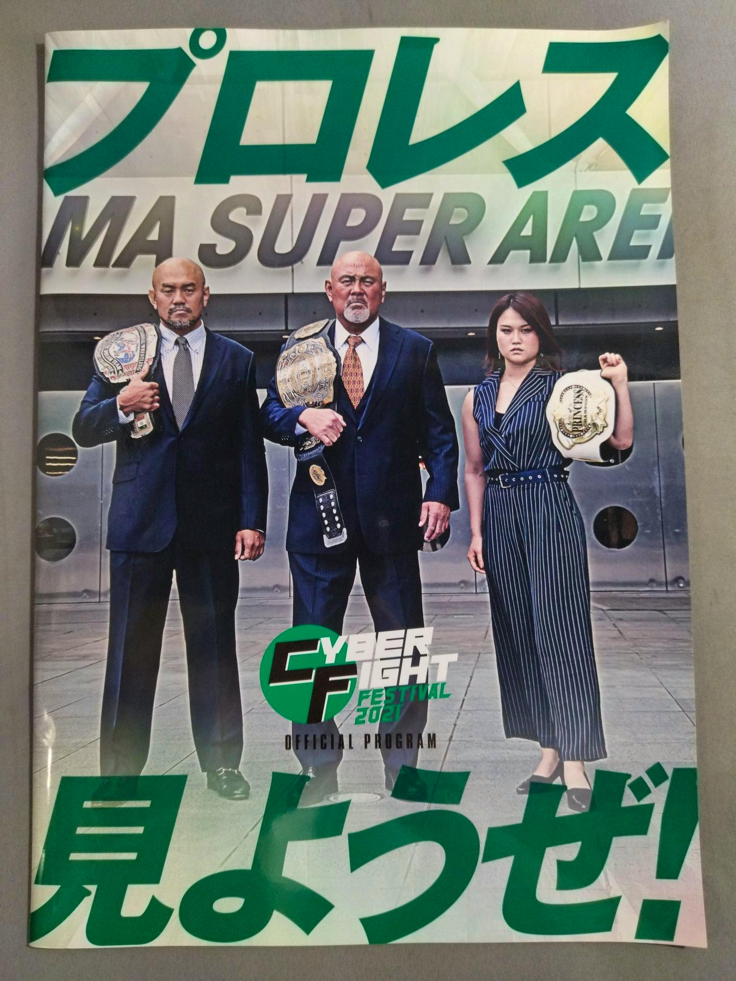 Cover of the "Let's watch Cyber Fight Festival 2021 / Pro Wrestling!" magazine showing three people in suits holding championship belts and the Cyber Fight Festival 2021 logo.