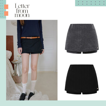 A model wearing the striped layered skirt pants on the left, with two flat product photos of the skirt-pants in gray and black on the right.