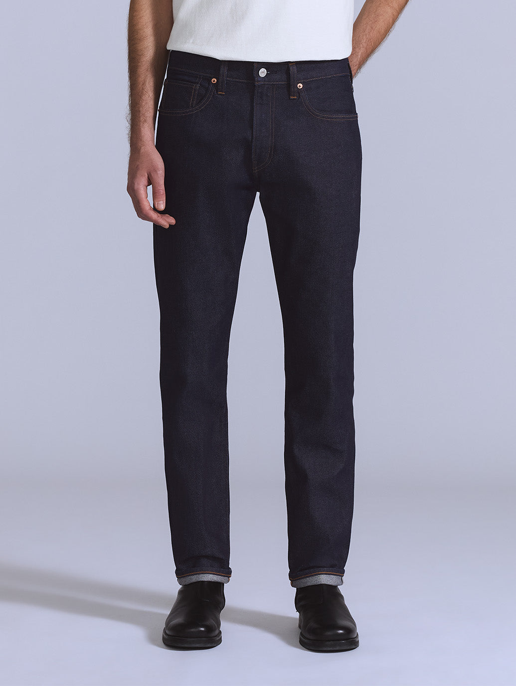 Front view of a model wearing BLUETAB 502 tapered-fit dark indigo men's jeans.