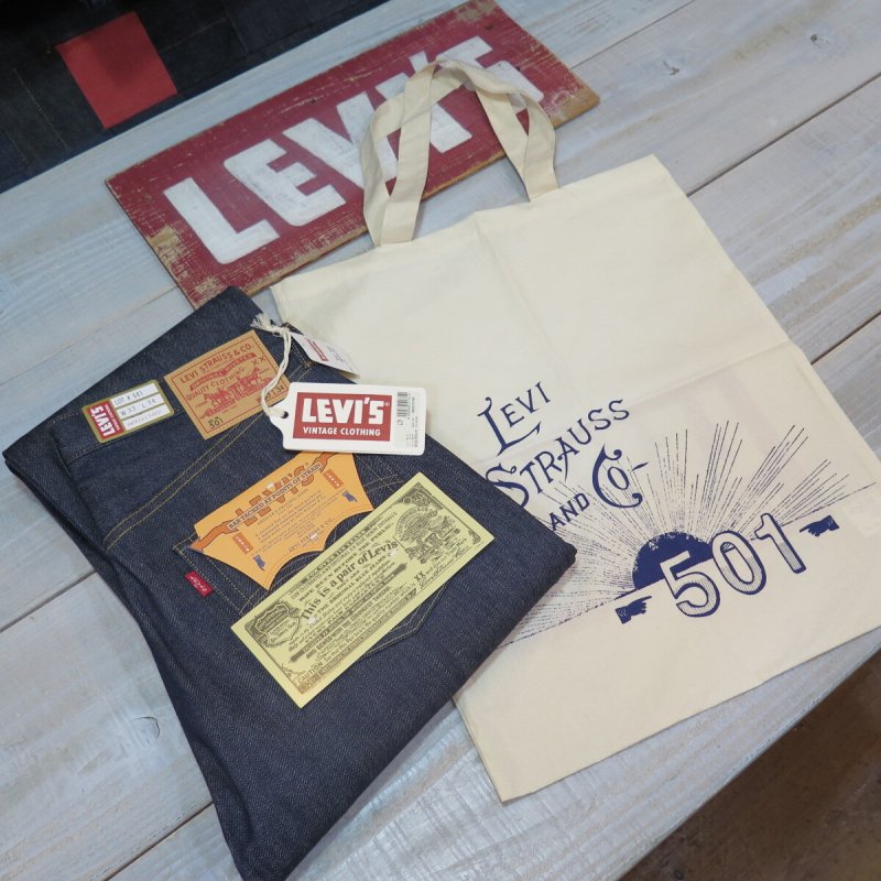 Folded Levi's 501XX jeans with original tags displayed next to a Levi's 501 printed tote bag.