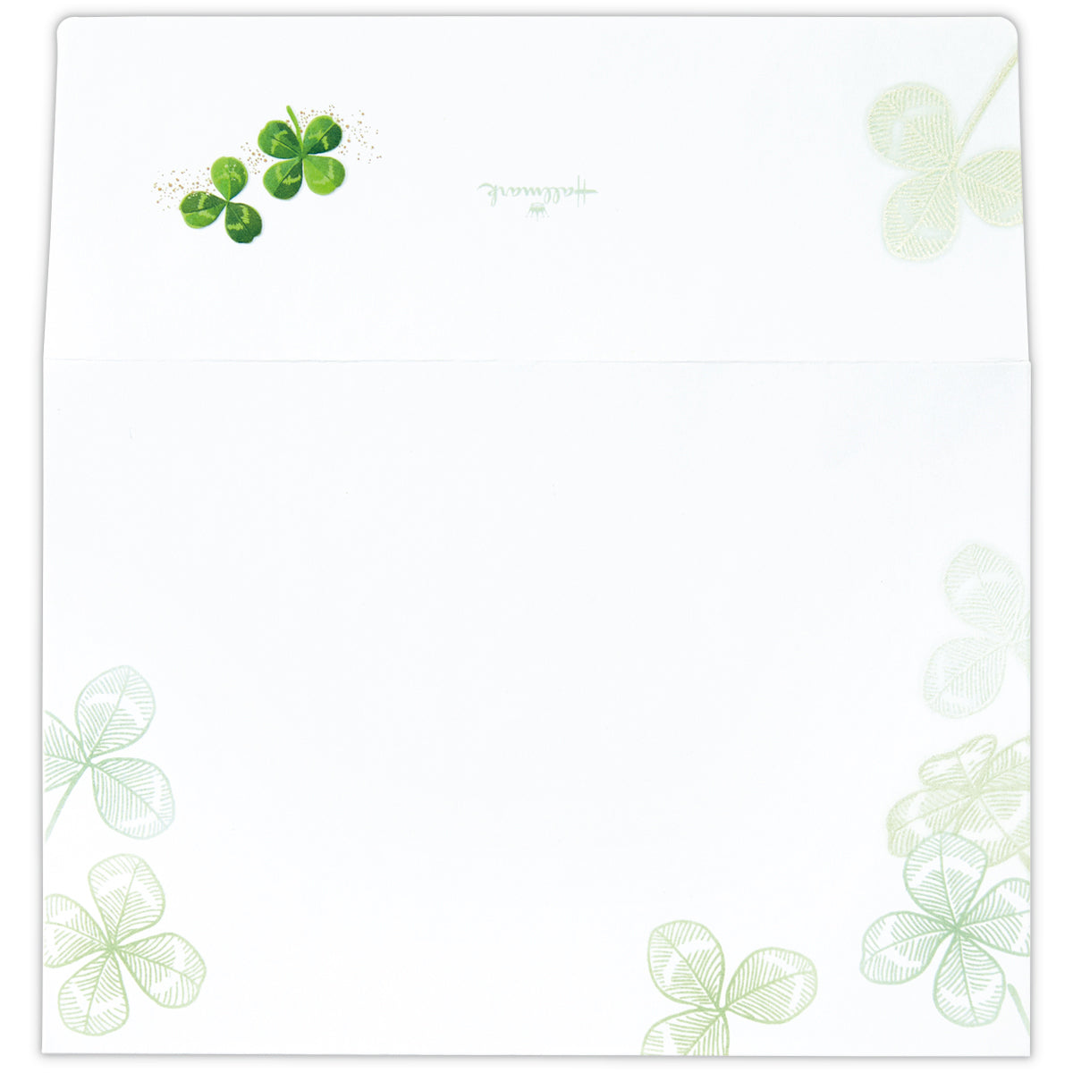 White envelope showing green clover illustrations on the flap and lower corners.