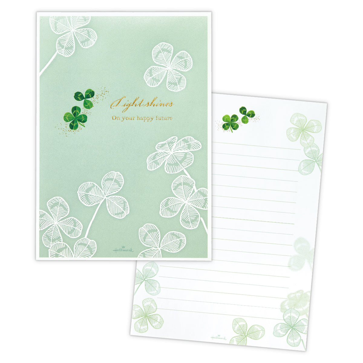 Two pieces of letter paper from the set: a green clover-themed cover sheet and a lined writing sheet with clover decorations.