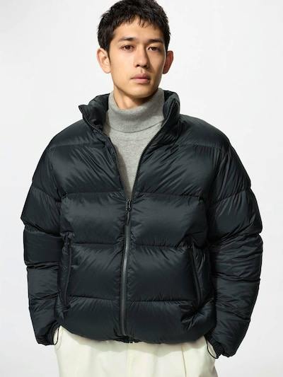 Male model wearing a black men's nylon down jacket, front view with the zipper closed.