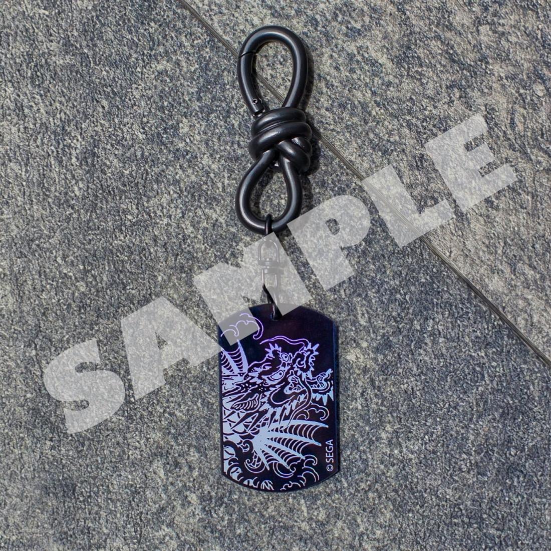 Aurora acrylic keychain with dragon artwork attached to a black knot-style clip on a textured background.