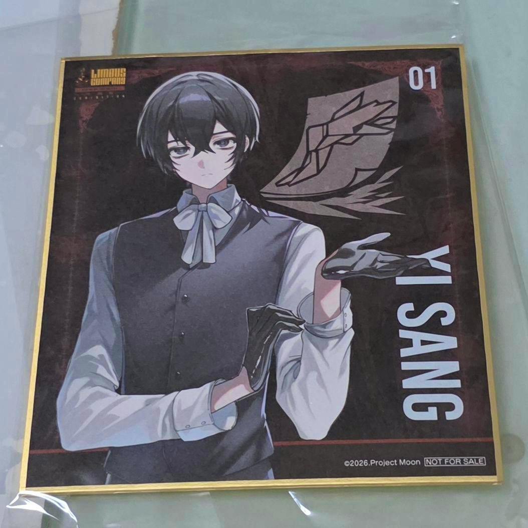 Photo of the Limbus Company mini shikishi picture board showing the character イサン (Isan) artwork in a plastic sleeve.
