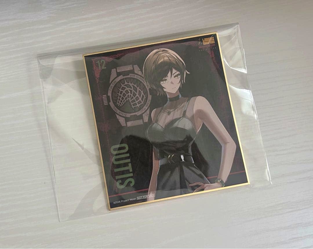 A Limbus Company -地獄篇- EXHIBITION 色紙 (ウーティス) art board in a clear plastic sleeve on a light wood surface.
