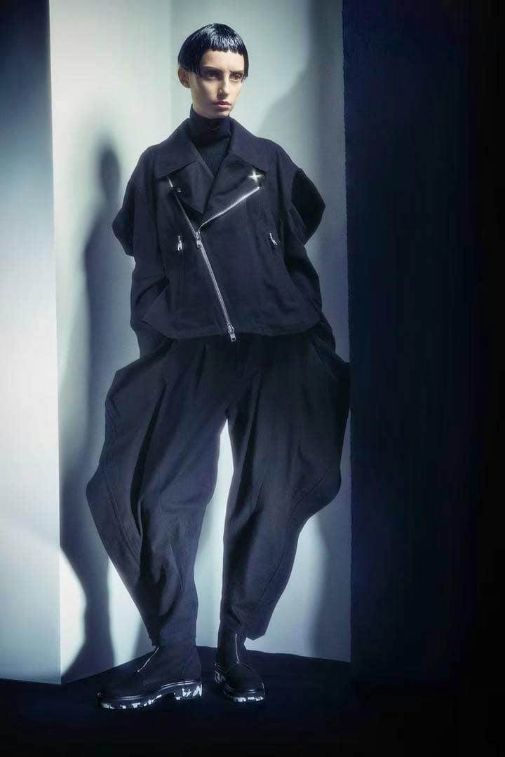 Full-length photo of a model wearing black LIMI feu sarouel pants.