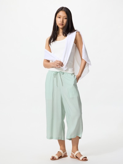 Model wearing linen-blend easy women's pants (longer length) in light green, standing full-length with a drawstring waist.