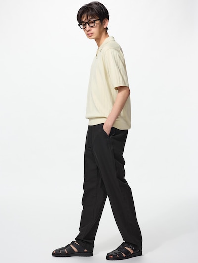 Male model standing in profile wearing the men's linen-blend easy pants and a light short-sleeve top.