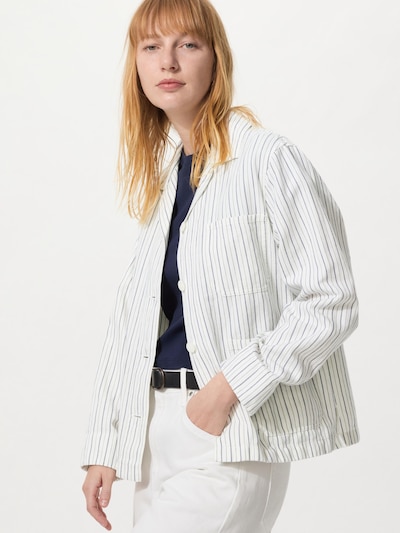 Woman modeling a striped women's jacket on a white background.