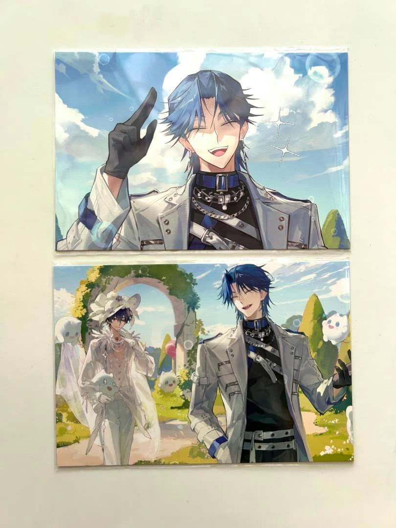 Photo of two illustrated postcards showing a blue-haired male character in a grey jacket and a scenic card with another character, placed on a white background.