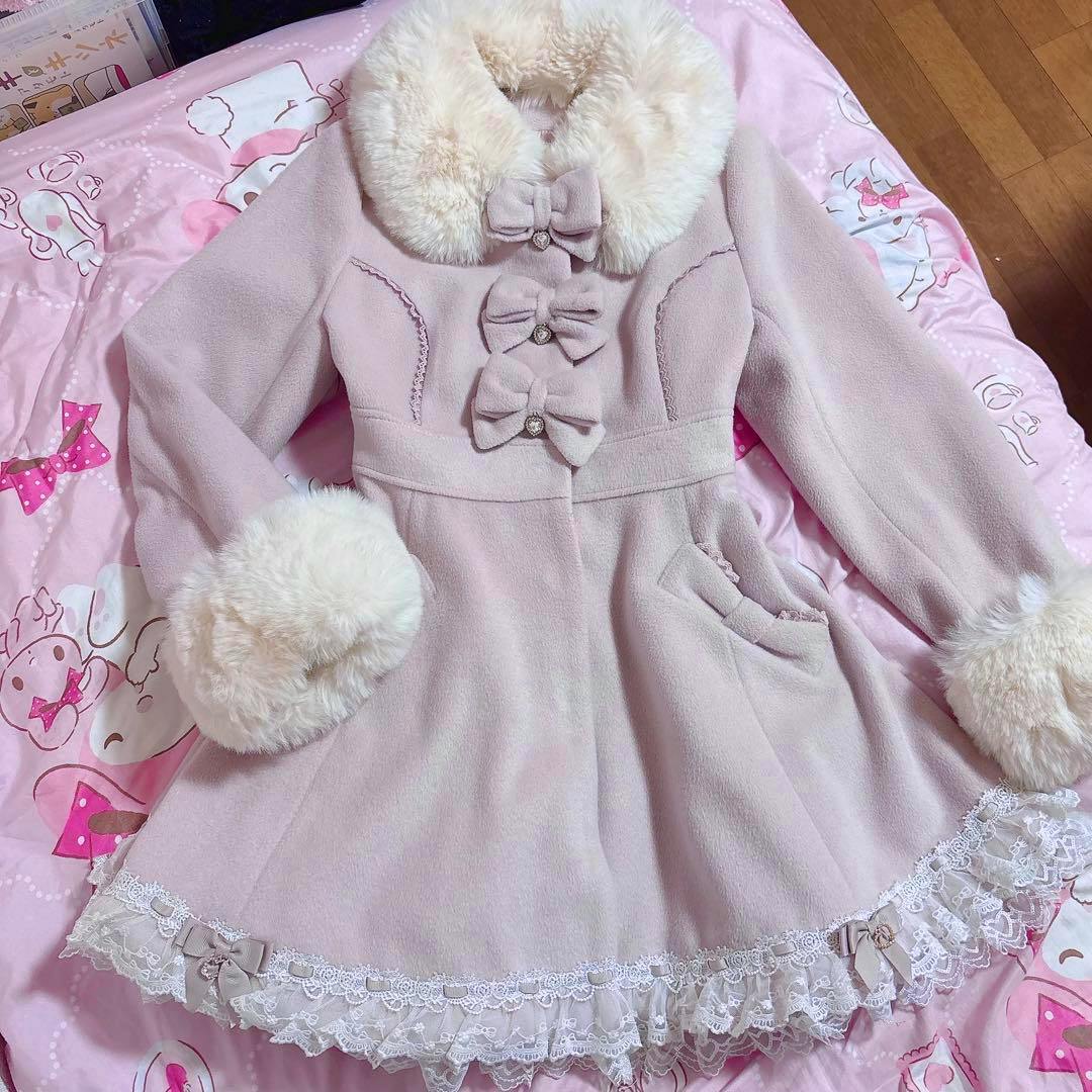 Pink LIZLISA ribbon coat laid flat showing faux fur collar and cuffs, three front bow closures, pockets, and lace-trimmed hem.