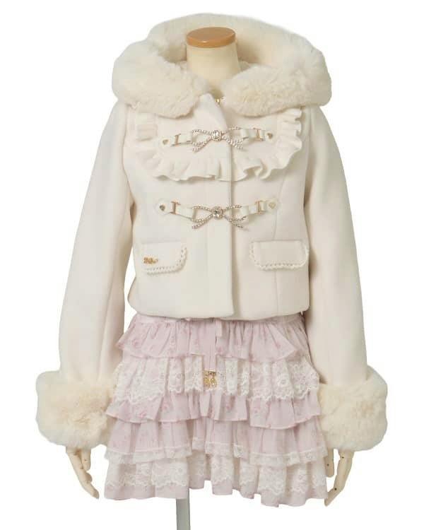 White short hooded coat with fur trim, ruffled front and jeweled ribbon closures shown on a headless mannequin.