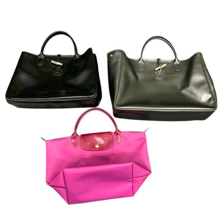Three Longchamp tote bags (two black and one pink) photographed on a white background.