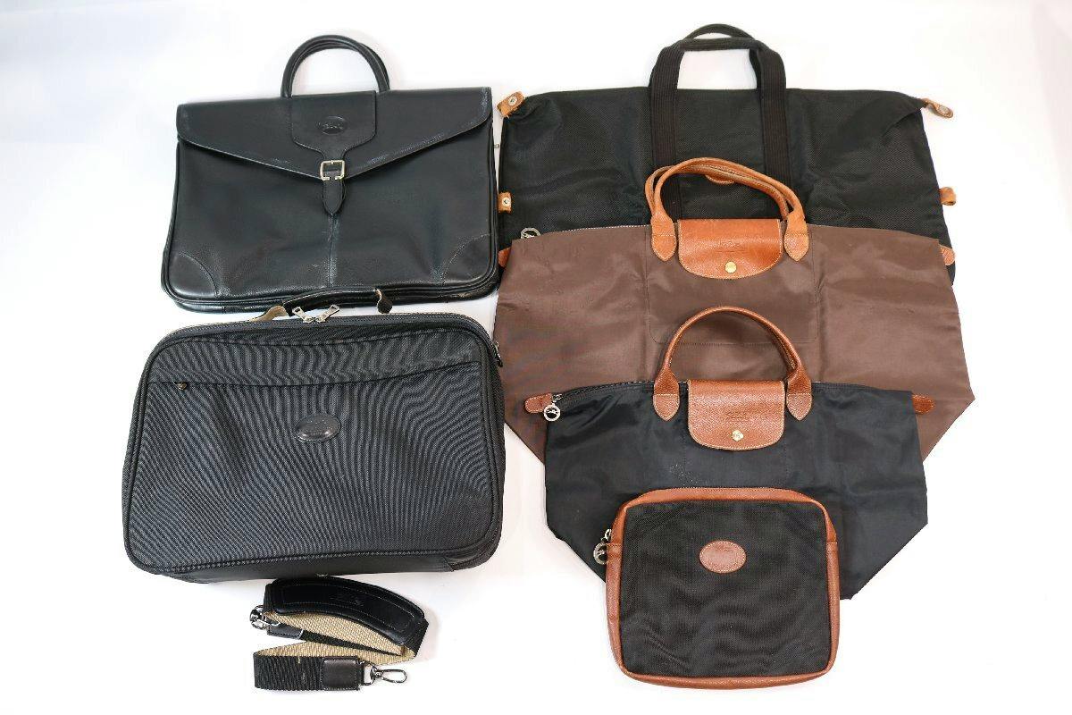 Six Longchamp bags of various styles and sizes (totes, briefcase, pouch) arranged on a white background.