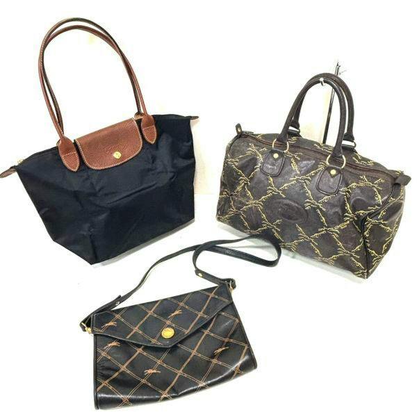 Three Longchamp bags—a black tote, a brown patterned handbag, and a black crossbody—laid out on a white background.