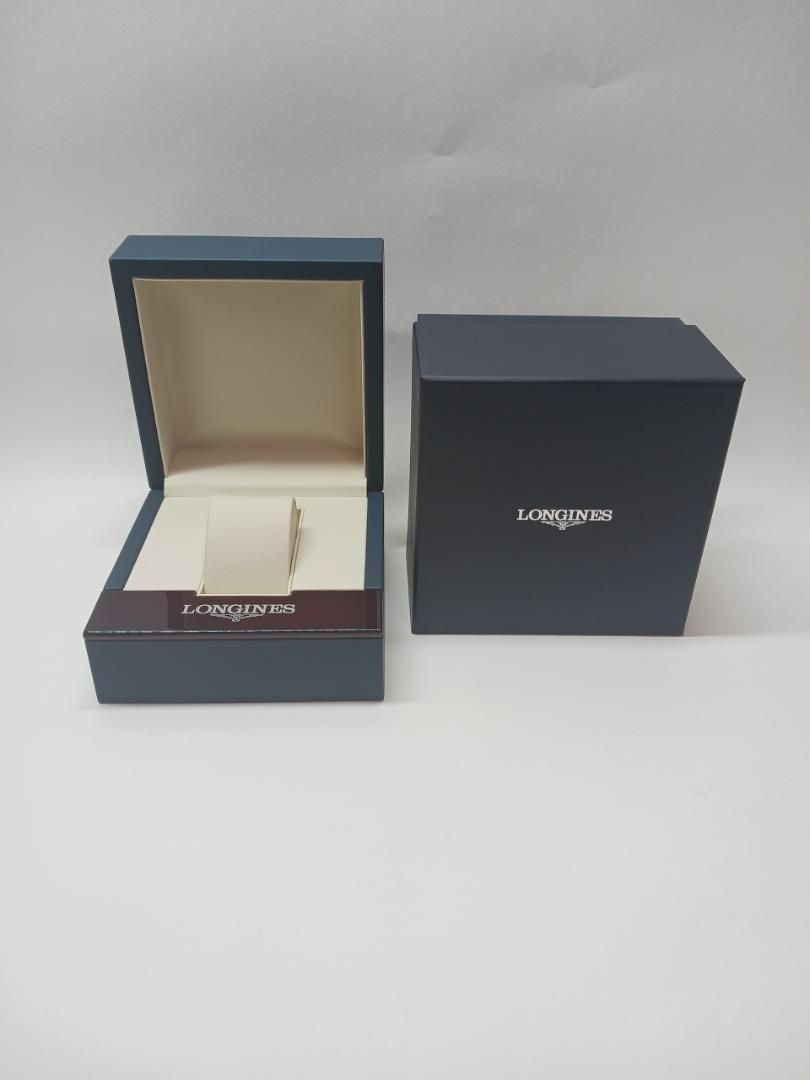Open navy Longines watch box showing a beige interior and a navy outer box with the Longines logo.