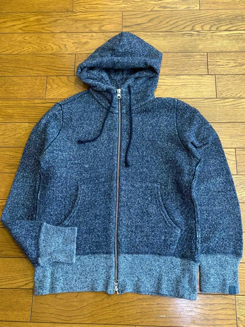 LOOPWHEELER navy zip-up hoodie (size XS) laid flat on a wooden floor showing the front, zipper, hood, and pockets.