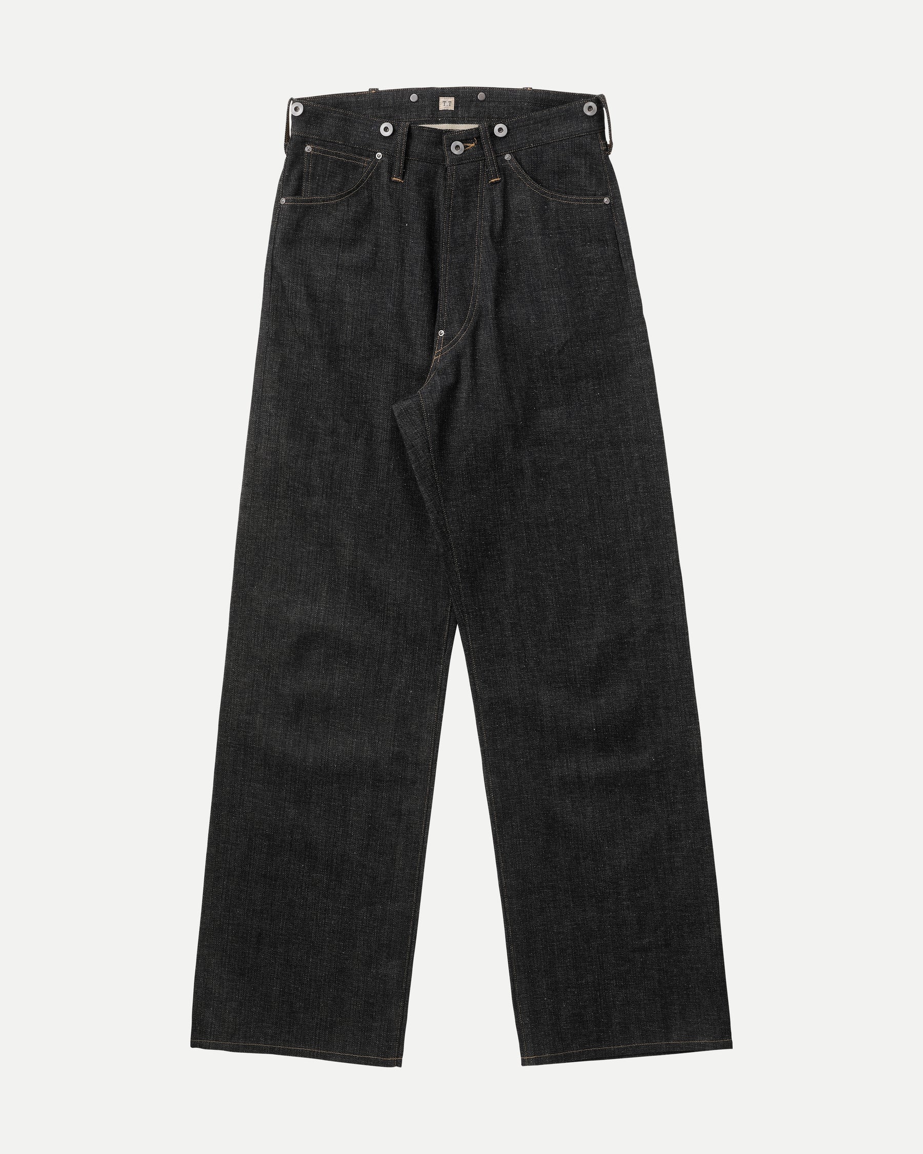 Front view of the LOT.704 denim trousers laid flat showing front pockets and button fly.