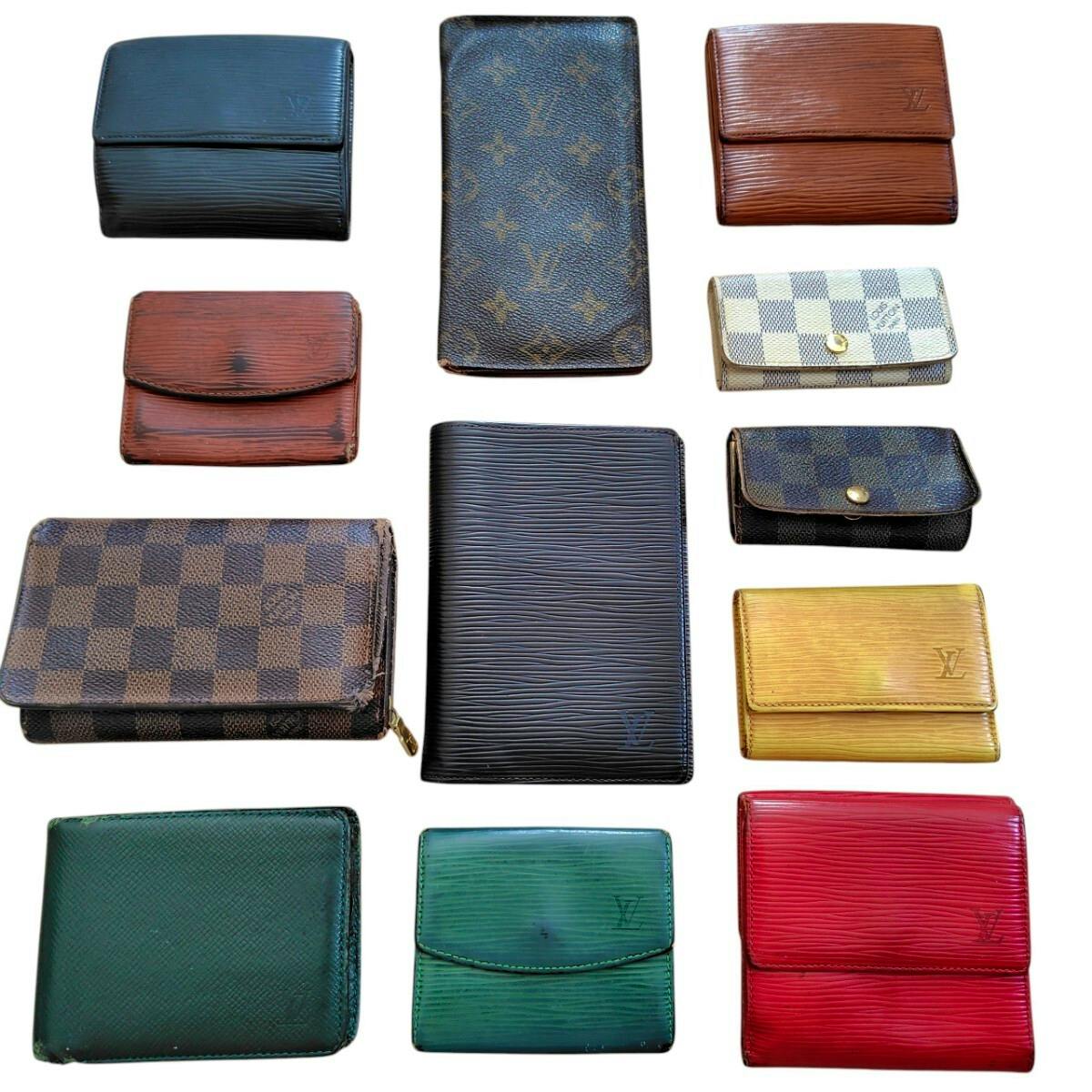 Twelve Louis Vuitton wallets and small leather goods in various colors and patterns arranged on a white background.