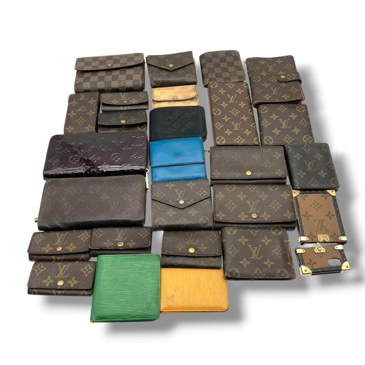 Multiple Louis Vuitton small leather goods and wallets in monogram, Damier, Épi, and Vernis styles arranged on a white background.