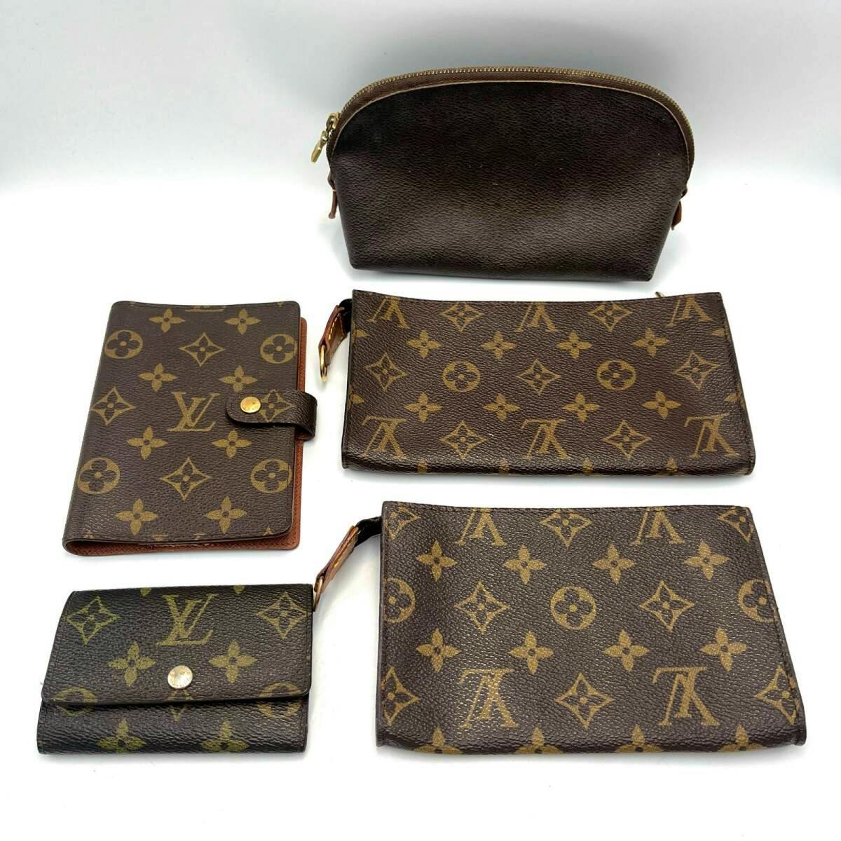 Five Louis Vuitton monogram canvas items (pouch, key case, notebook cover and two small wallets) arranged on a white background.