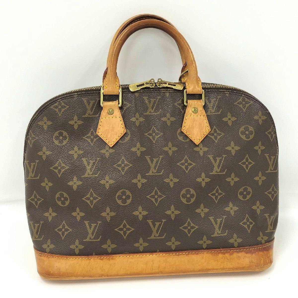Front view of the Louis Vuitton Alma monogram handbag showing the monogram canvas, leather trim, and handles.
