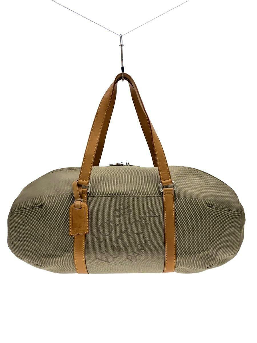 Khaki nylon Louis Vuitton duffel bag with tan leather handles and visible "LOUIS VUITTON PARIS" embossing.