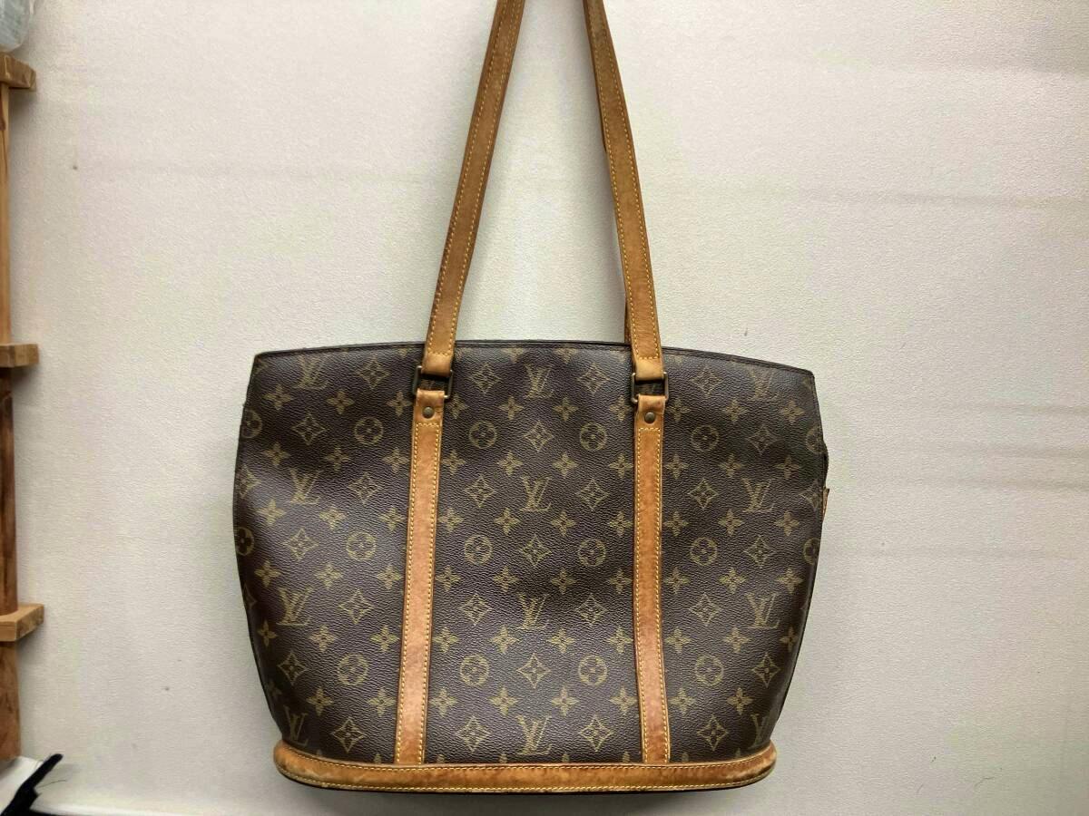 Front view of a Louis Vuitton Monogram tote bag with leather straps and trim.