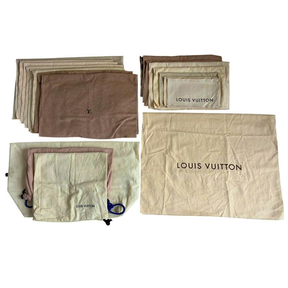 Several Louis Vuitton cotton dust bags in cream and brown laid flat, with the LOUIS VUITTON logo visible on some.