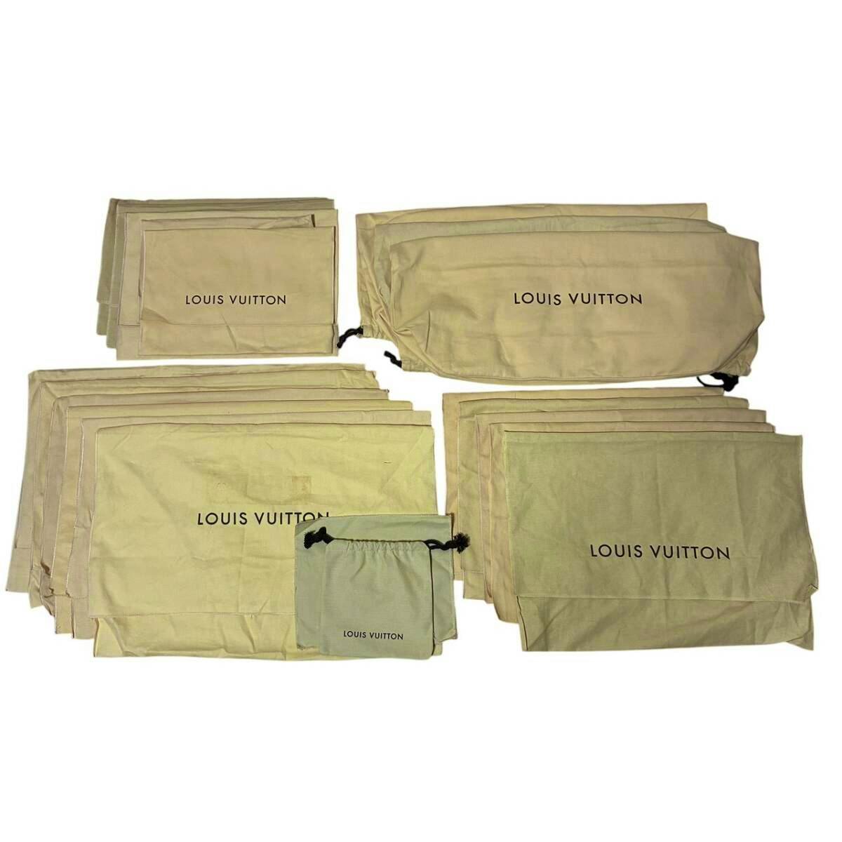 Several beige Louis Vuitton cotton dust bags in different sizes laid flat, each printed with "LOUIS VUITTON".