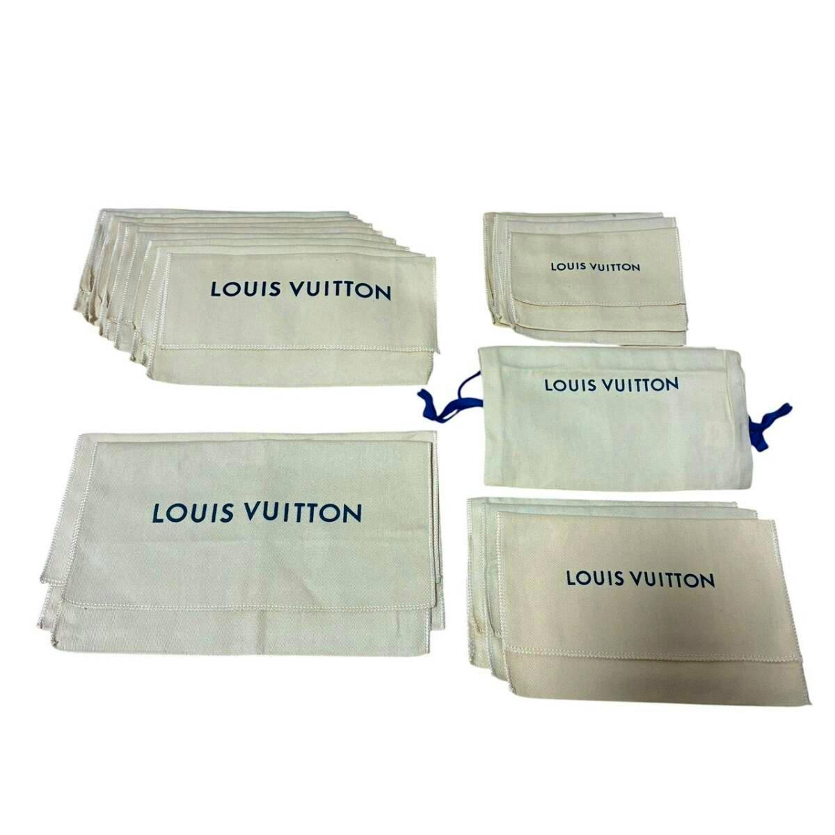 Multiple beige Louis Vuitton dust bags and pouches with "LOUIS VUITTON" printed, arranged on a white background.