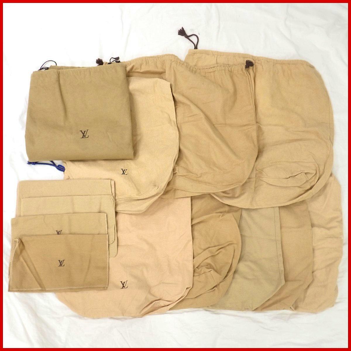 Several beige Louis Vuitton dust bags of various sizes laid flat, showing LV logos and drawstrings.