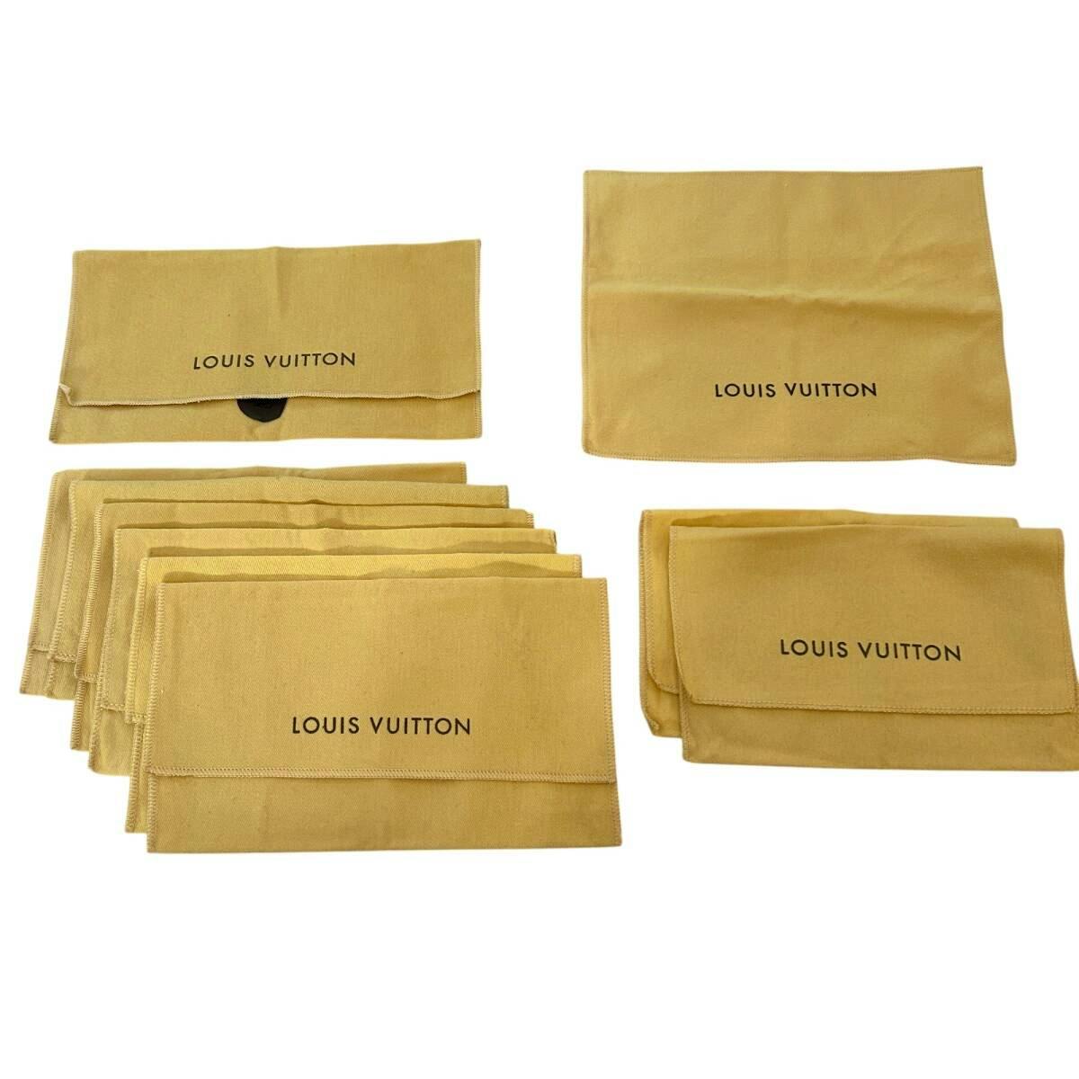 Several beige Louis Vuitton cotton dust bags with the 'LOUIS VUITTON' logo visible, arranged on a white background.