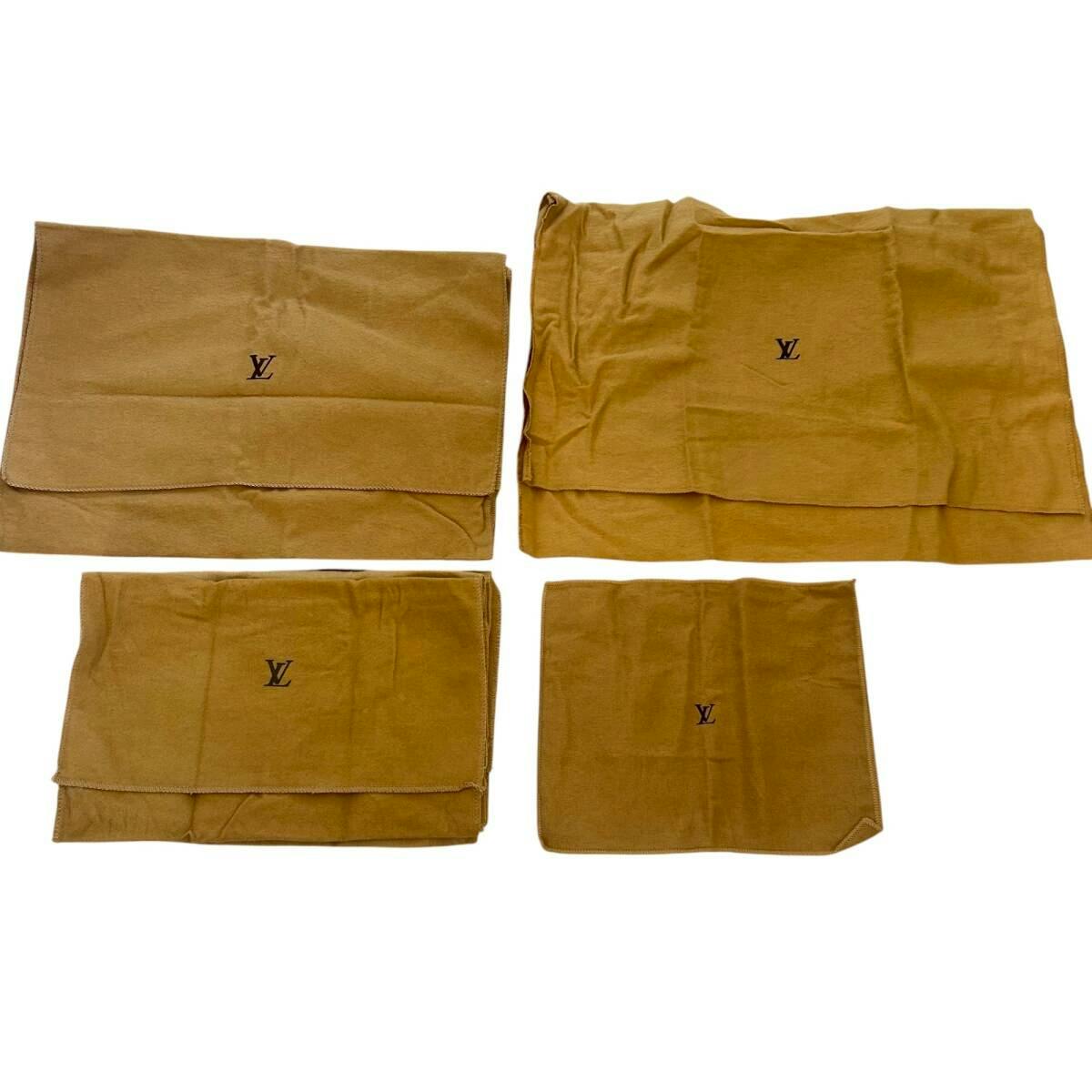 Four beige Louis Vuitton cotton dust bags laid flat, each showing the LV logo.