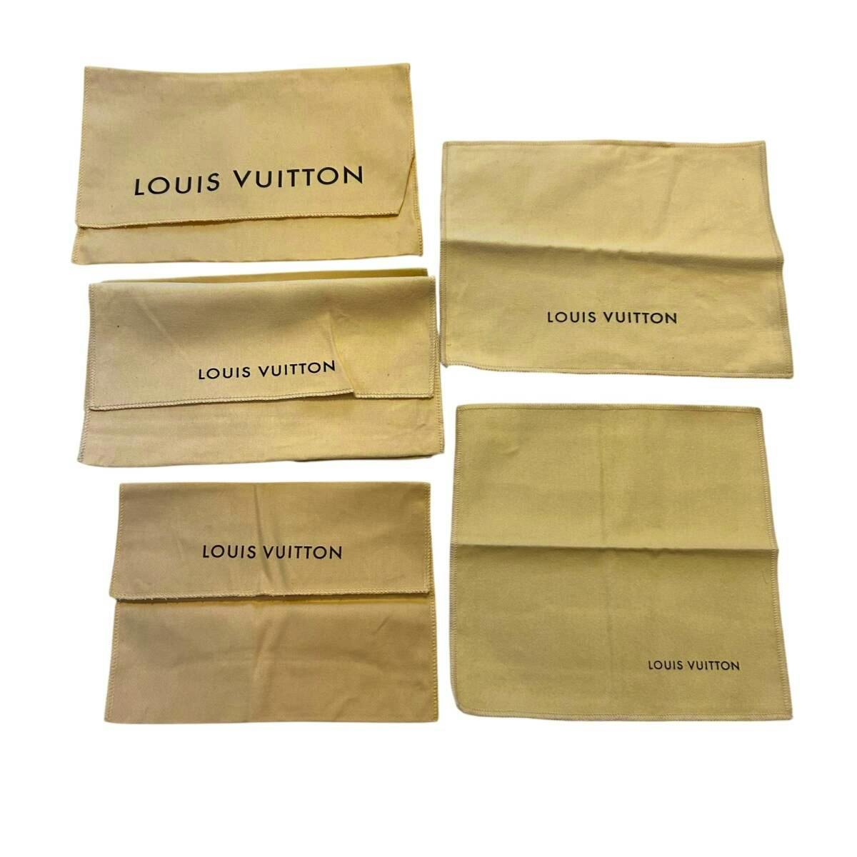 Several beige Louis Vuitton dust bags laid flat showing the Louis Vuitton logo.