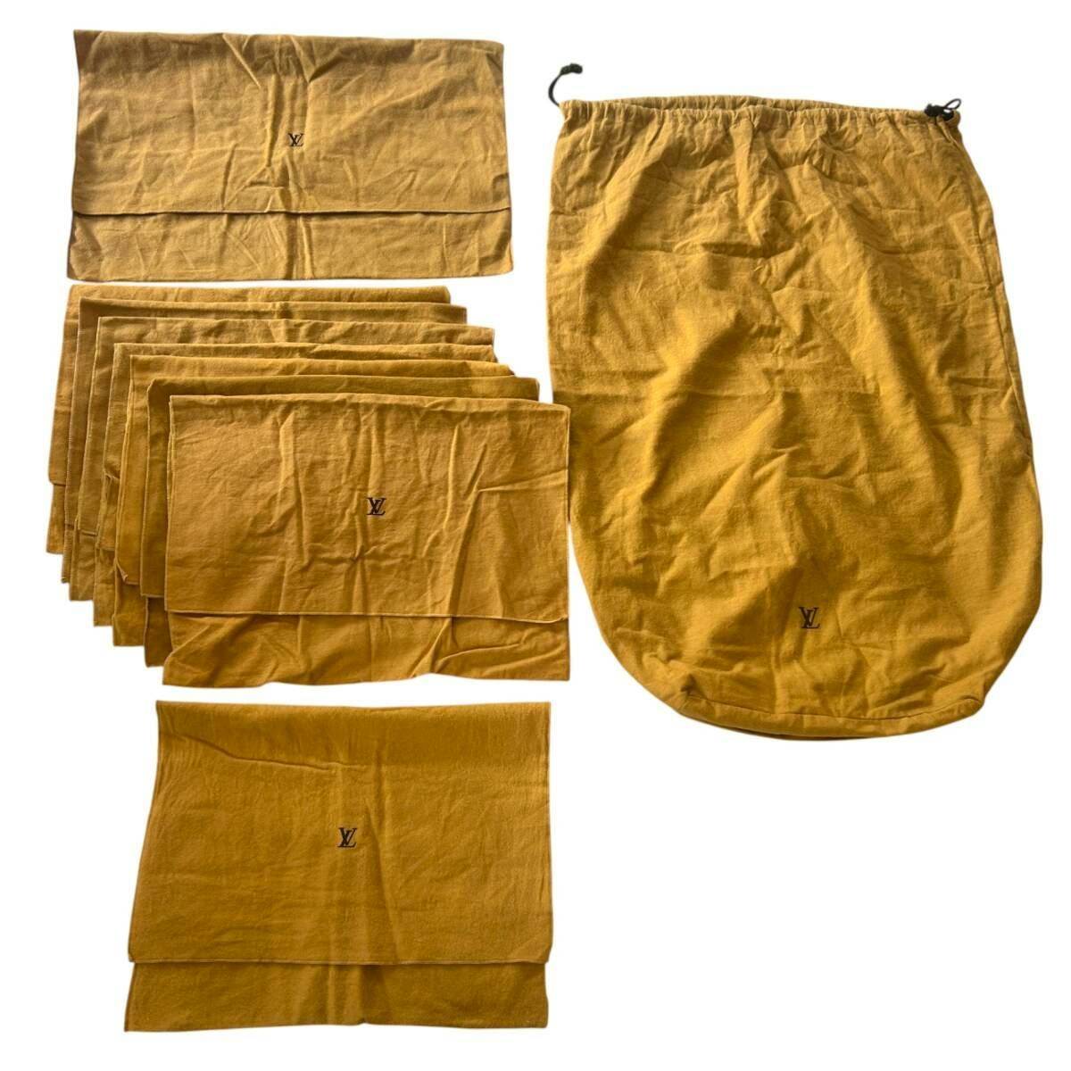 Several brown Louis Vuitton cotton dust bags of various sizes, including a large drawstring bag and multiple folded smaller bags, arranged on a white background.