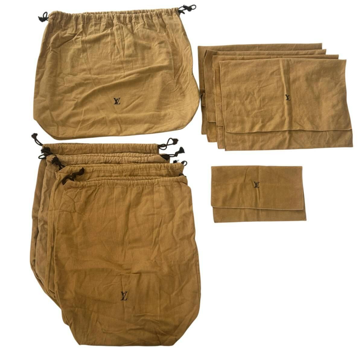Multiple brown Louis Vuitton cotton dust bags and pouches with visible LV logos and drawstrings.