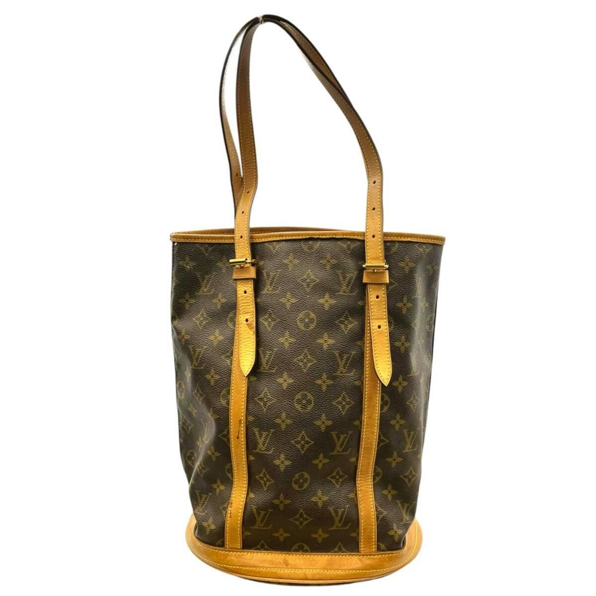 Front view of a Louis Vuitton monogram canvas bucket handbag with tan leather trim and long shoulder straps.
