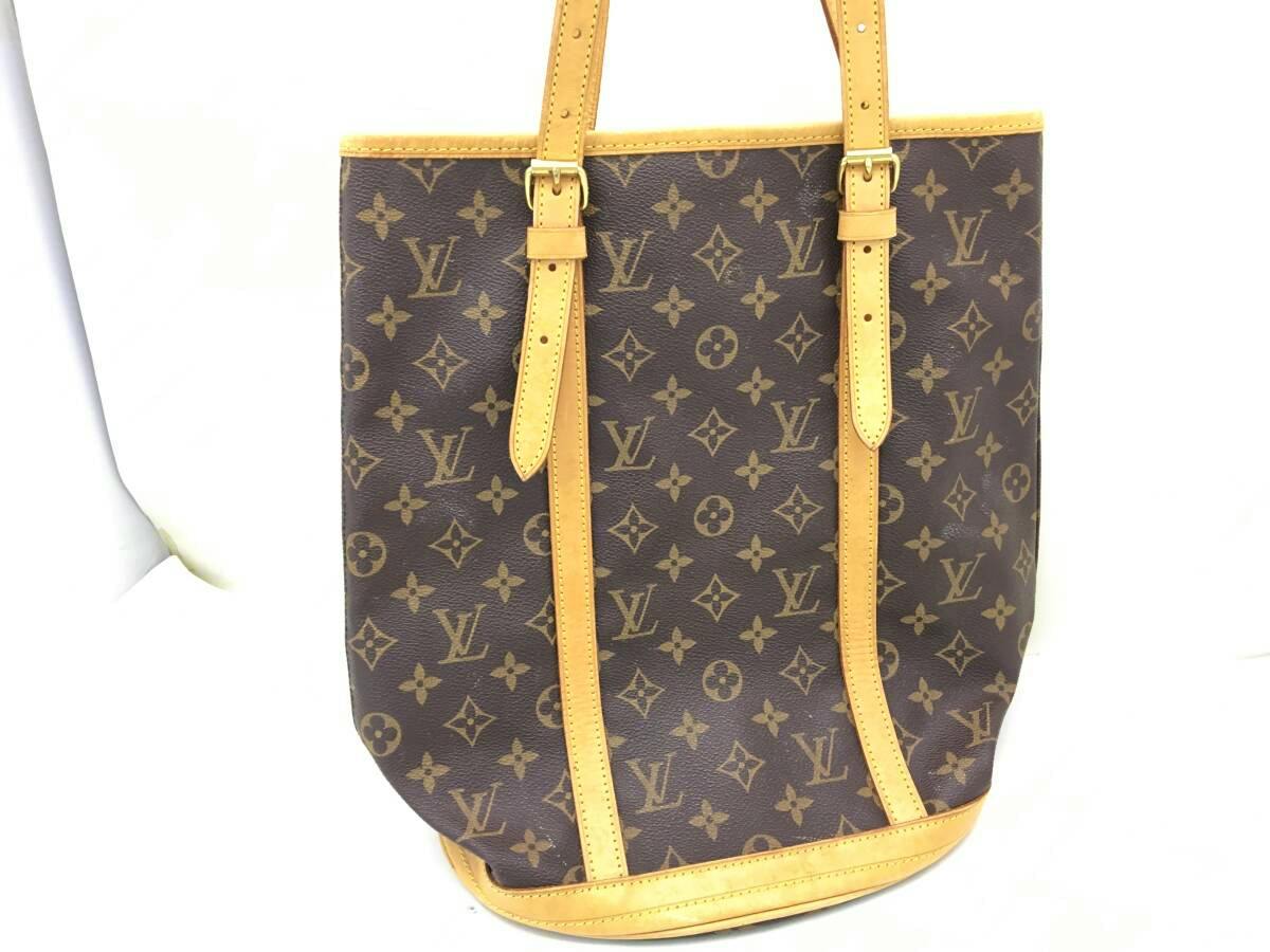Louis Vuitton monogram canvas bucket bag with two leather shoulder straps on a white background.